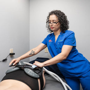RN at Chinn GYN placing Emsculpt NEO machine on patients buttocks